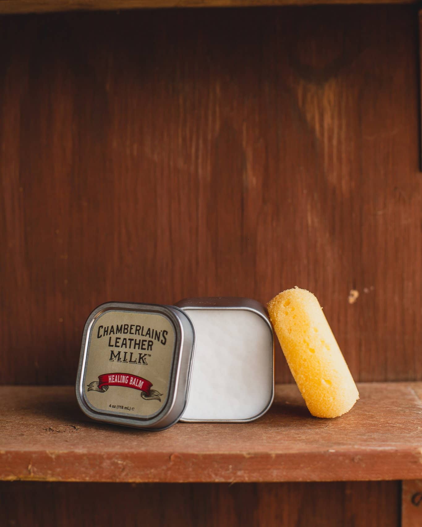 Chamberlins Leather Milk Healing balm on wooden shelf open with sponge