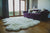 Nordvek sheepskin  natural rug 606-100 octo in front of sofa close up