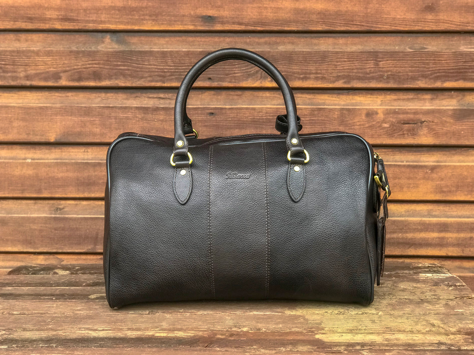 Ashwood leather holdall brown on wooden background back angle