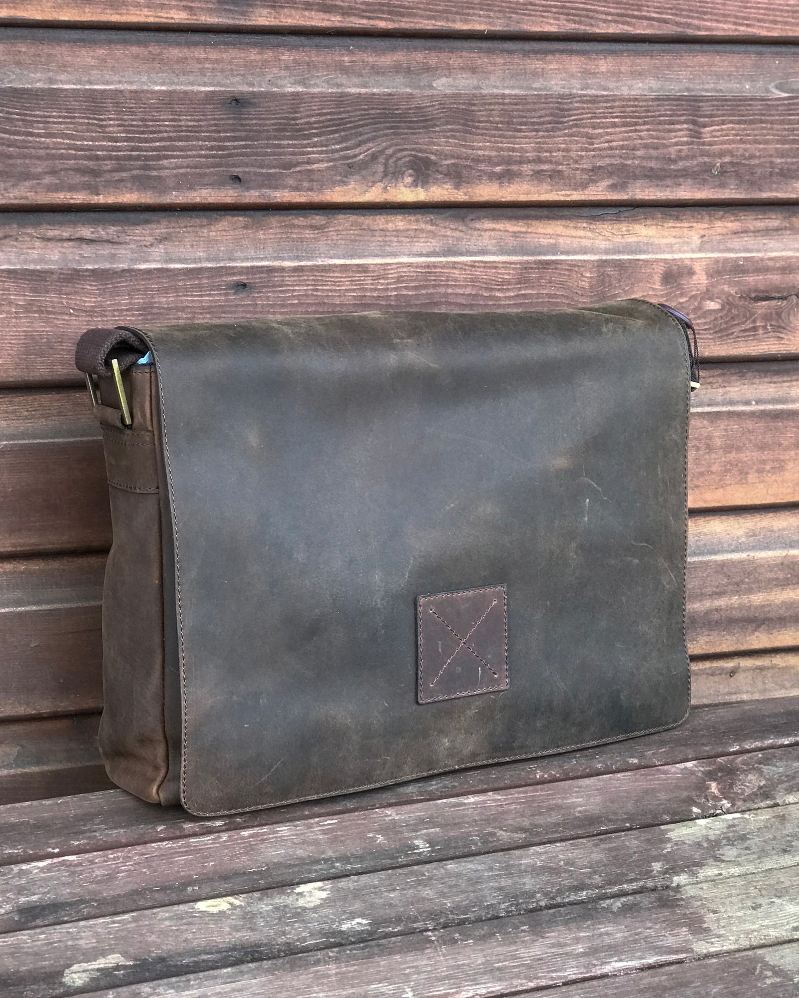 Ashwood collection of leather messenger bags brown mud on wooden bench
