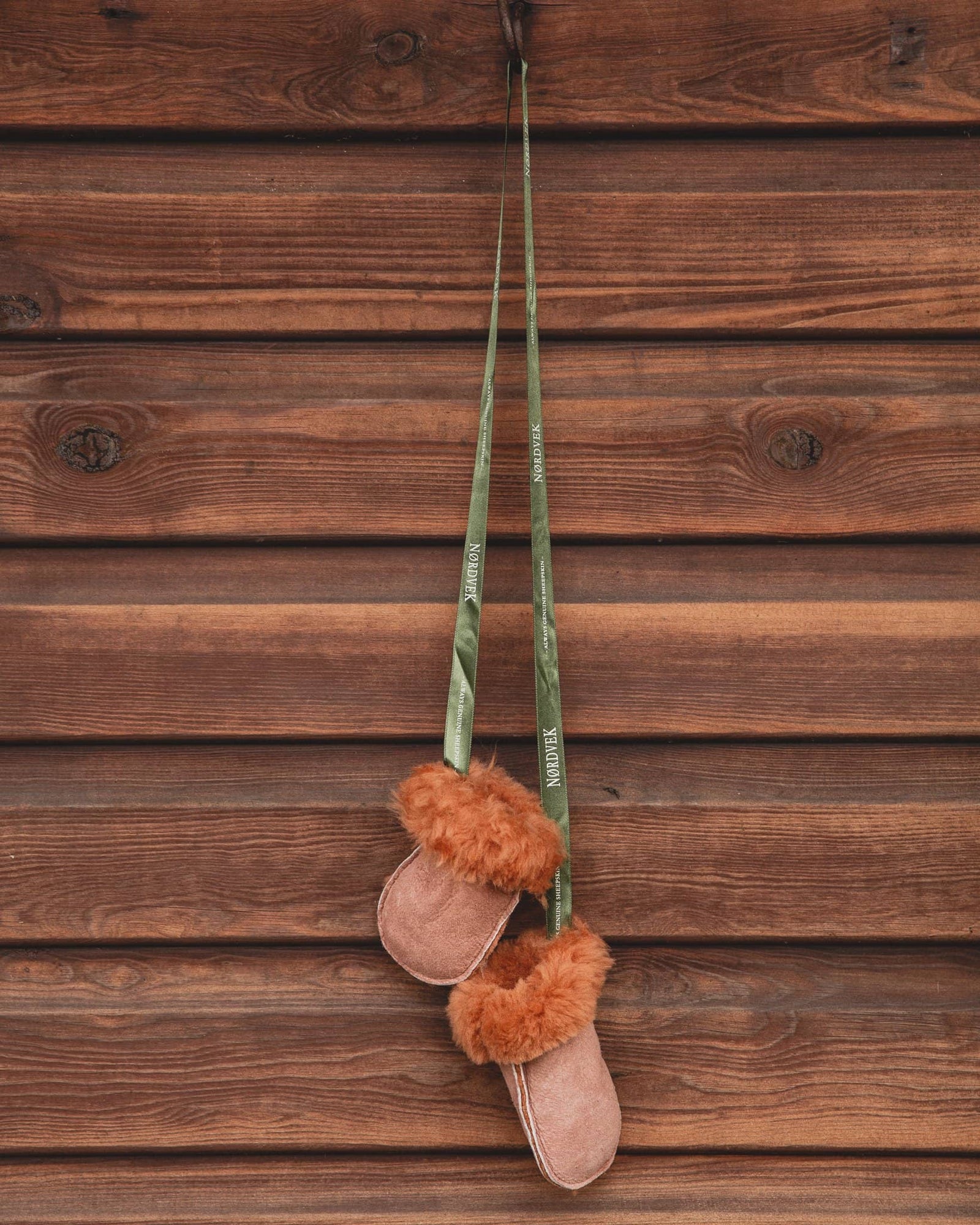 Kids Nordvek sheepskin puddy mittens 303-100 chesnut with green ribbon hanging on stables