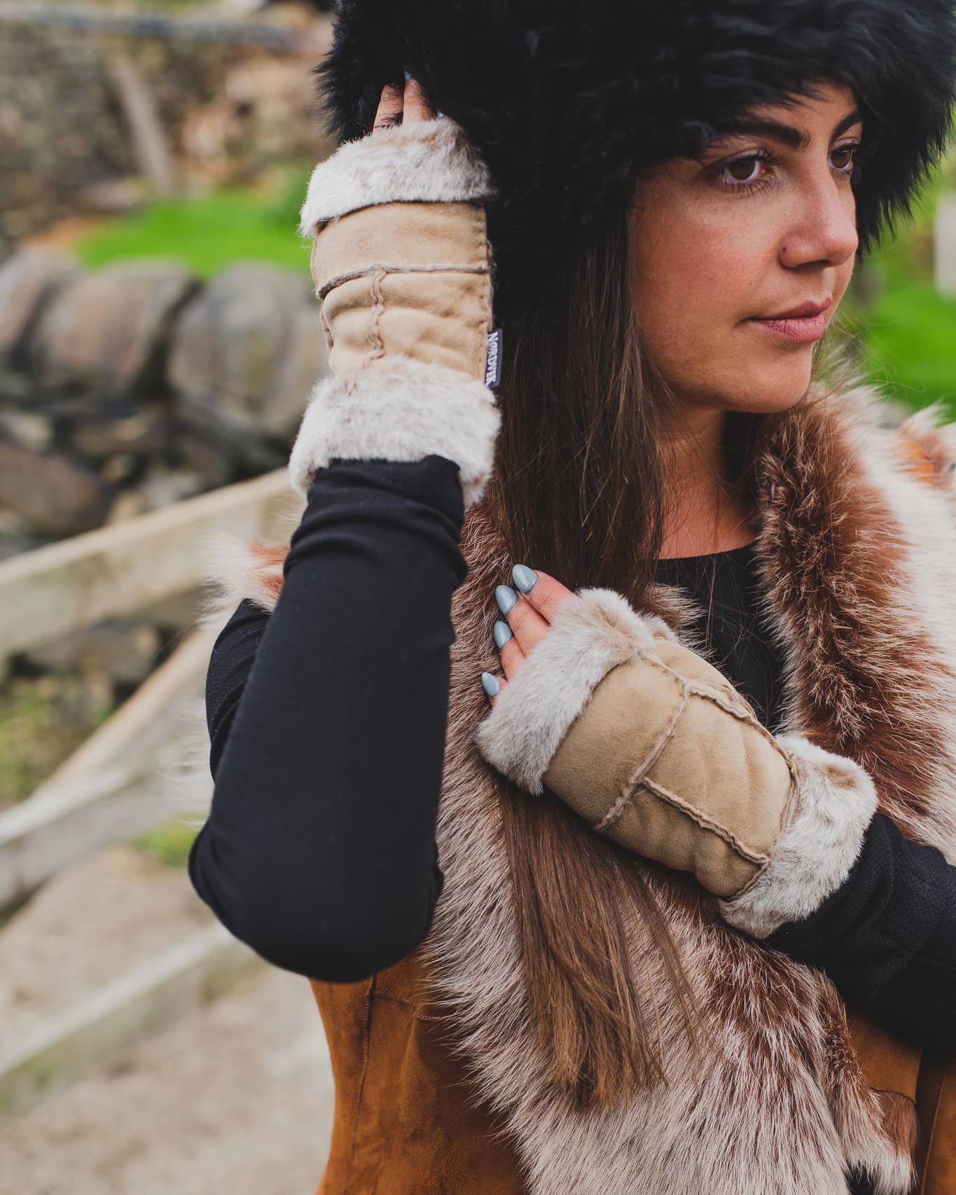 Nordvek womens sheepskin fingerless mittens 309-100 on model stroking hat