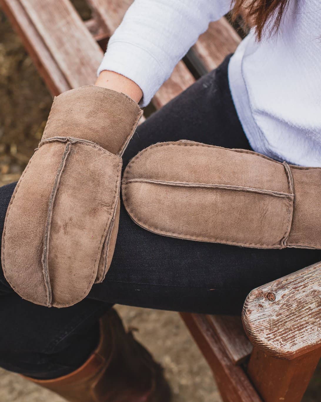 Nordvek womens sheepskin mittens model sat on bench