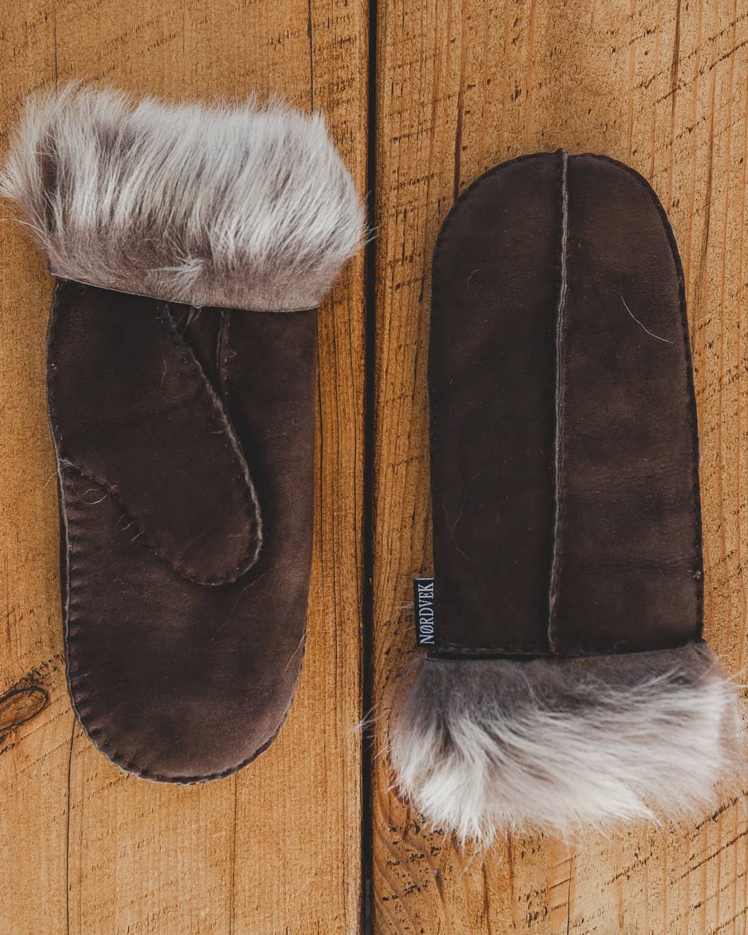 Nordvek womens sheepskin mittens chocolate colour opening wooden gate in field