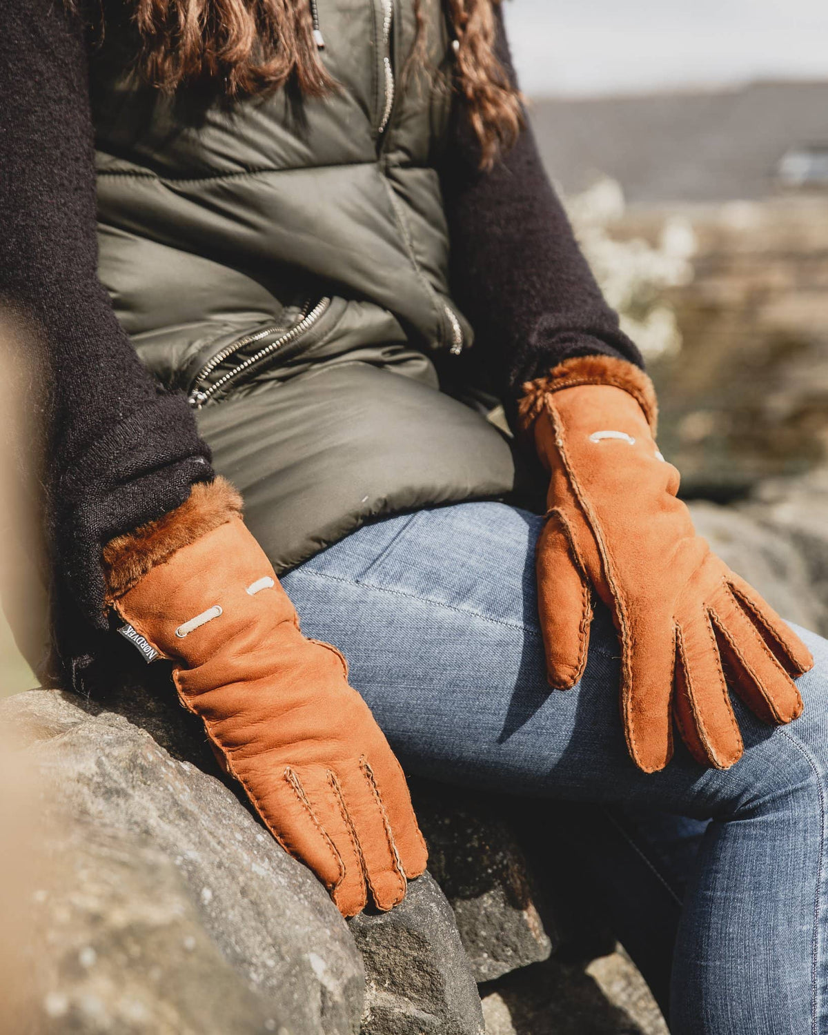 Nordvek womens sheepskin gloves 317-100 autumnal brown on model sat on wall