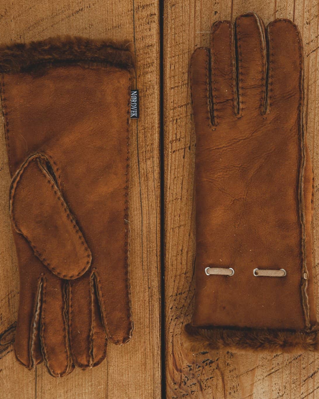 Nordvek womens sheepskin gloves 317-100 autumnal brown on model sat on wall