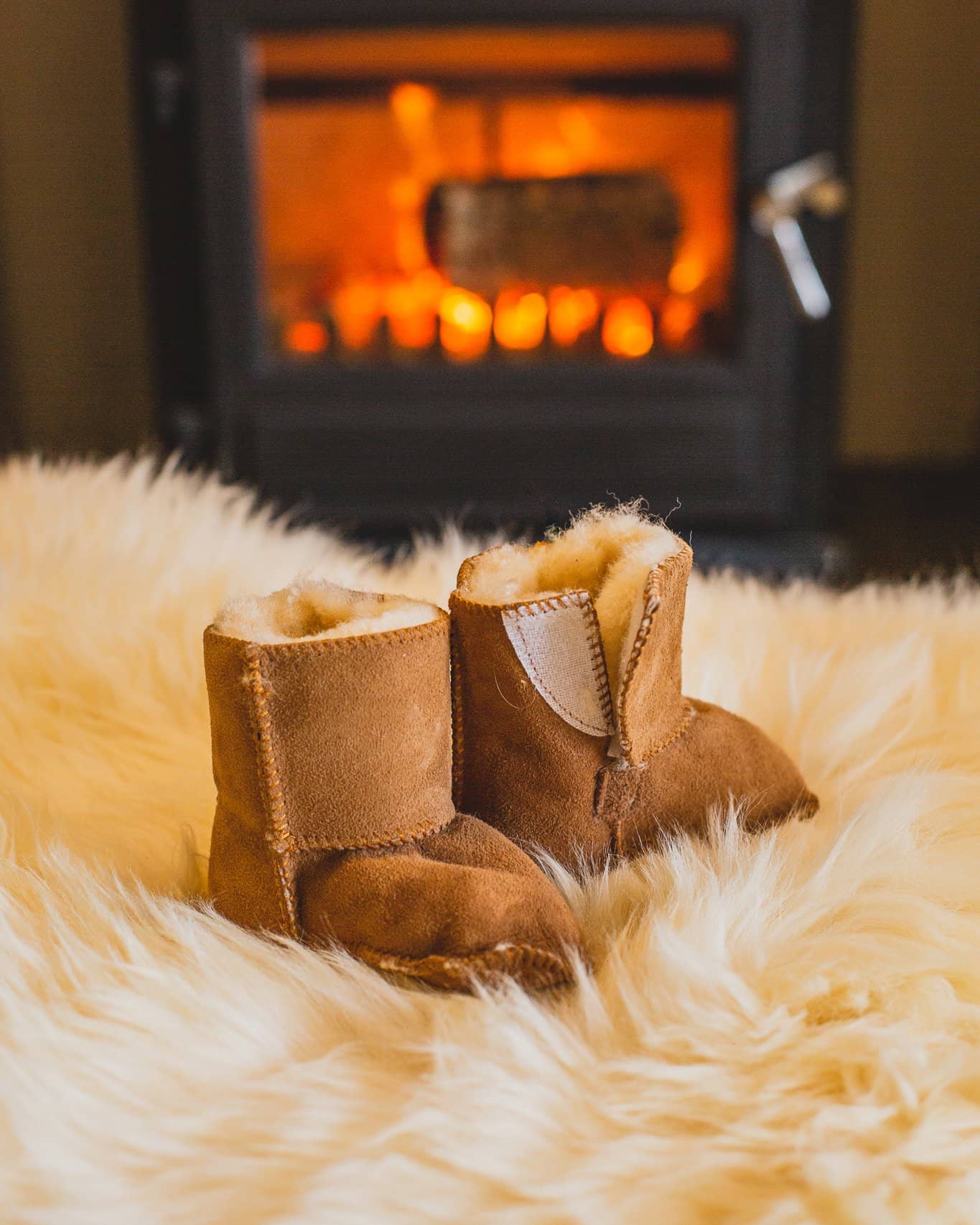 Nordvek baby booties 408-100 chestnut on rug infront of fire