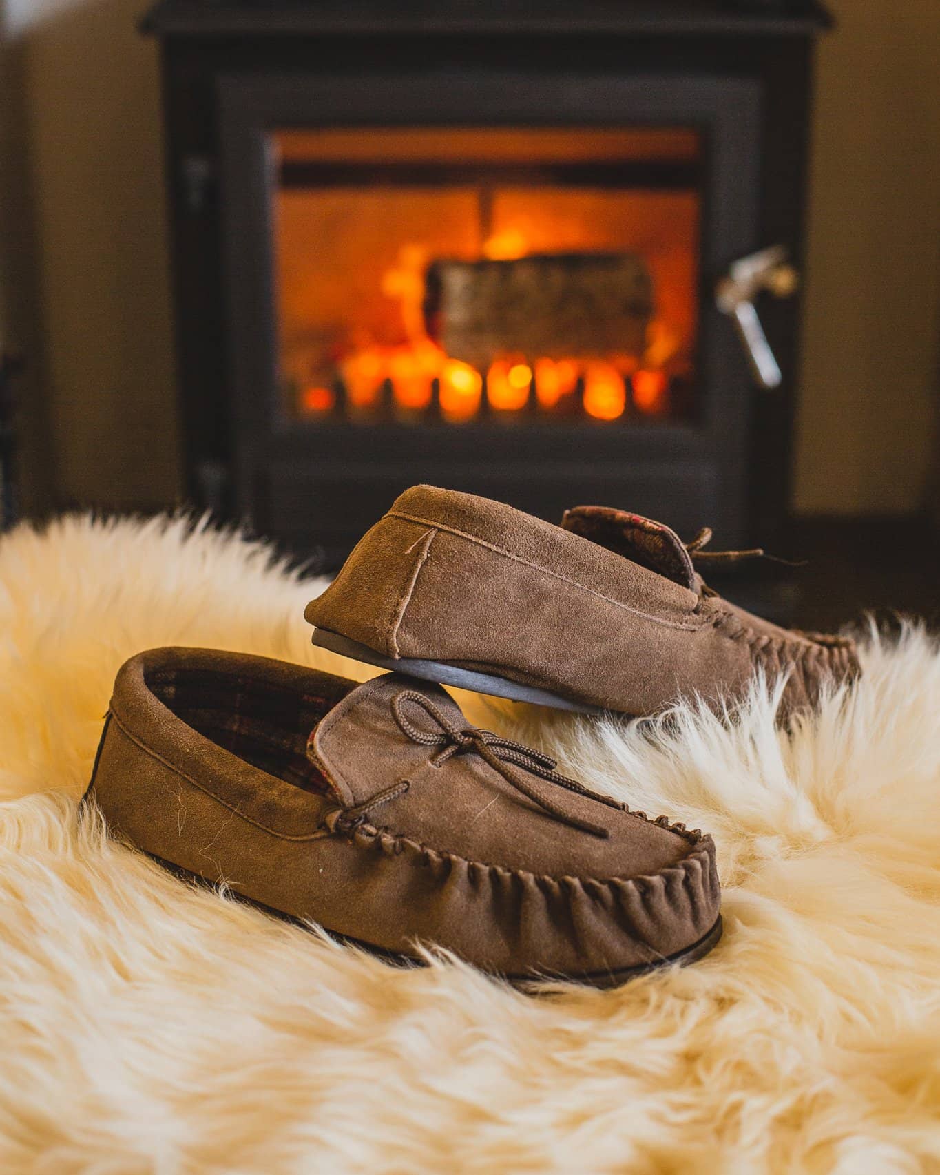 Nordvek mens moccasins hard sole  424-100 taupe in front of fire on pouffe