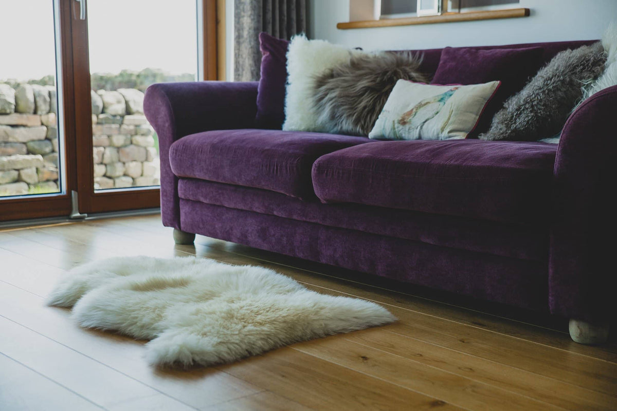 Nordvek sheepskin single rug 601-100 natural in front of sofa 
