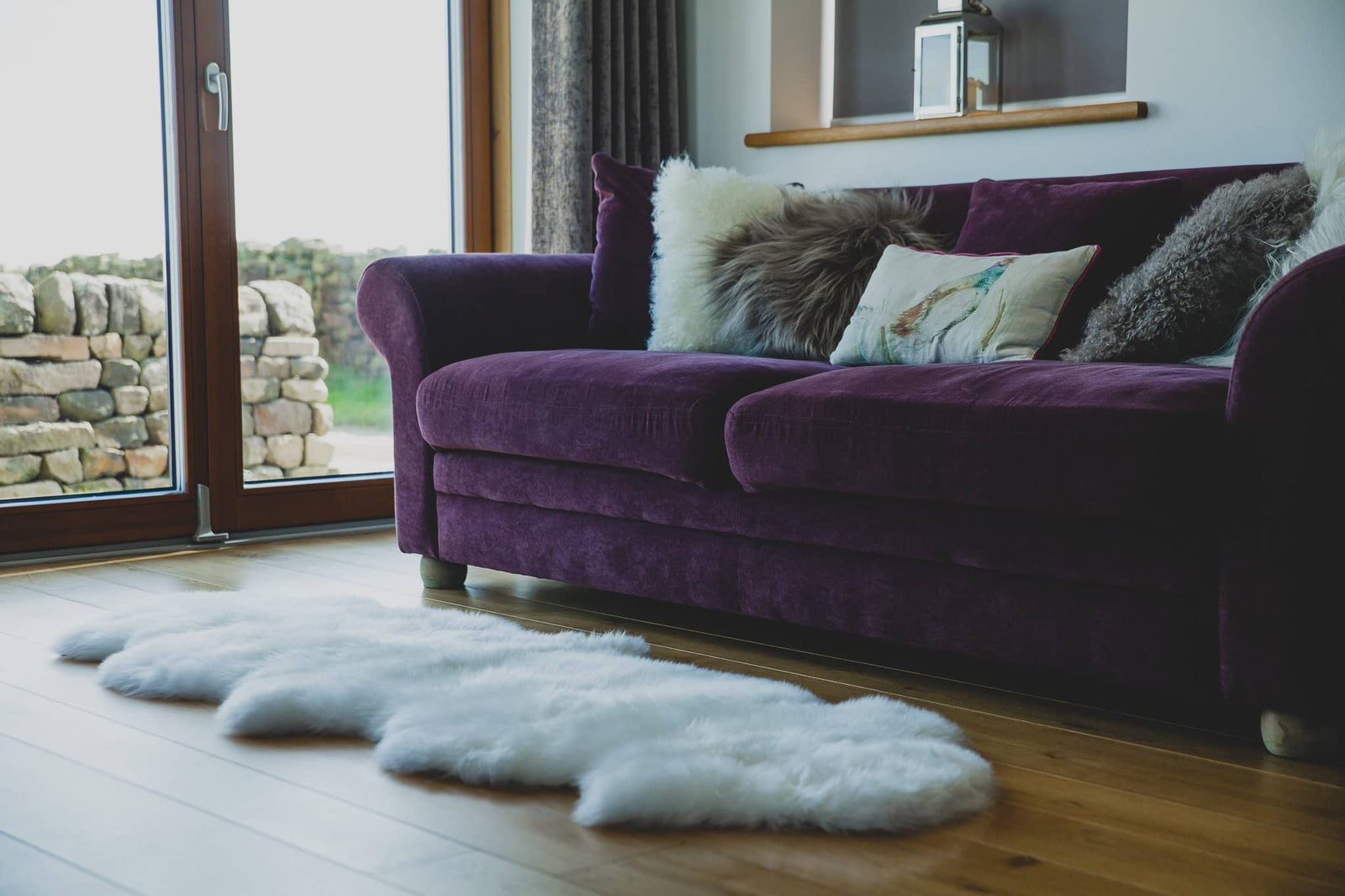 Nordvek sheepskin  natural rug 602-100 double in front of sofa close up