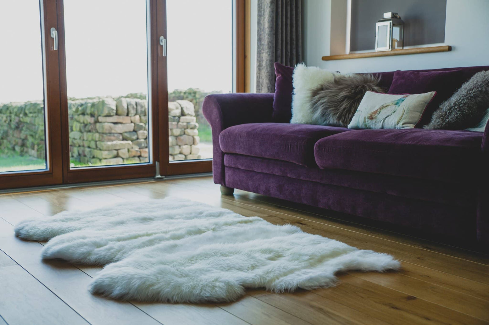 Nordvek sheepskin  natural rug 603-100 triple in front of sofa close up