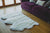 Nordvek sheepskin  natural rug 603-100 triple in front of sofa close up