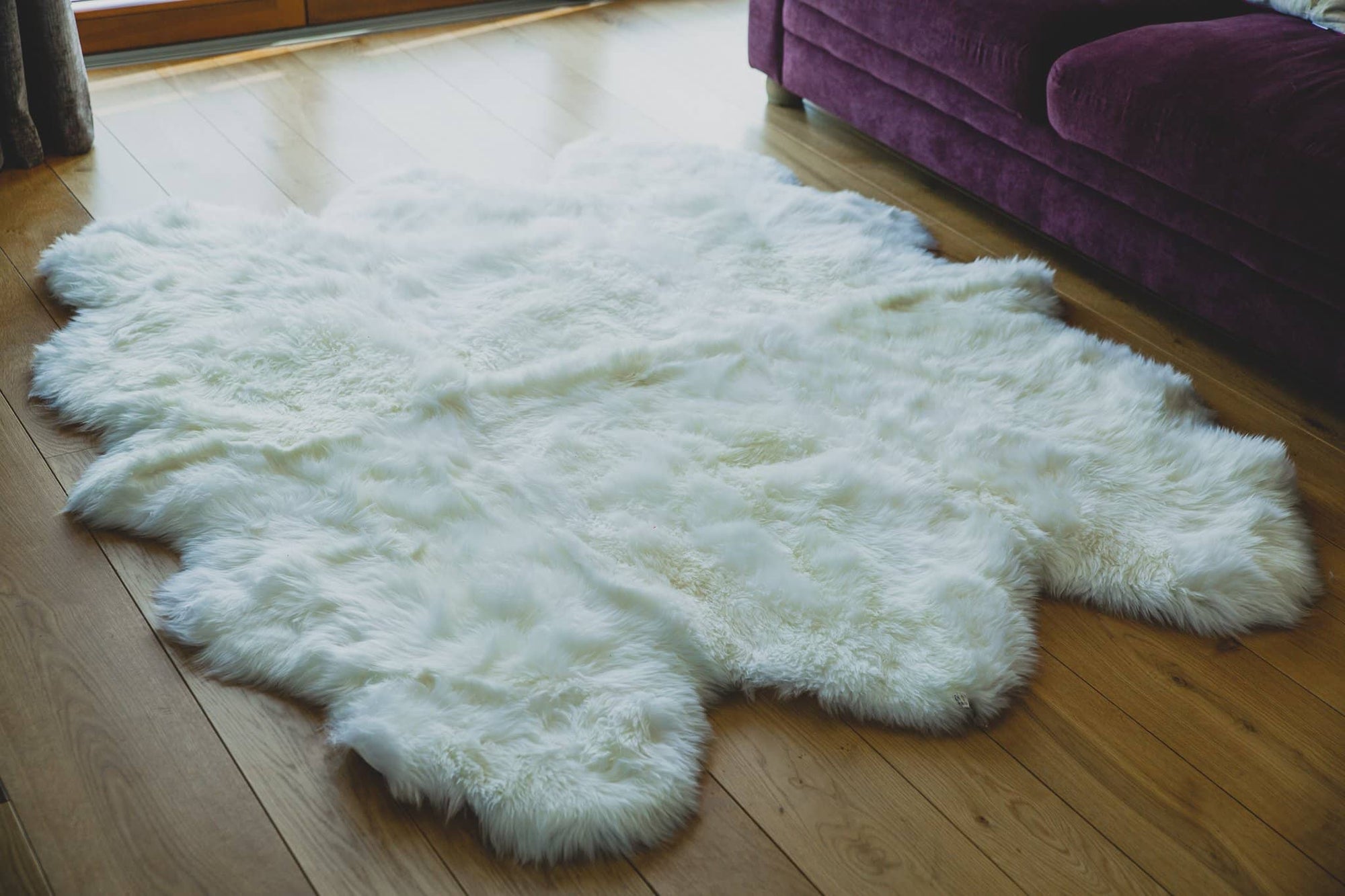 Nordvek sheepskin  natural rug 605-100 sexto in front of sofa close up