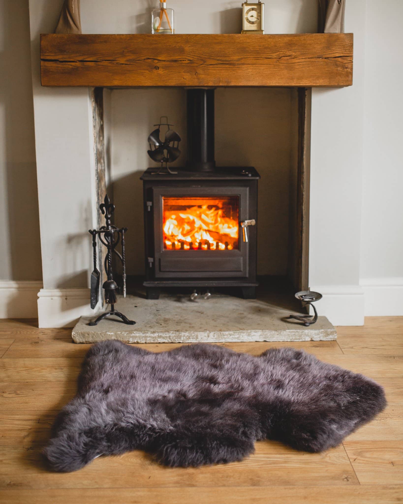 Nordvek sheepskin rug coloured grey in front of fire
