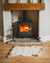 Nordvek Spanish sheepskin rug 616-100 design 1 in front of fire