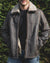 Nordvek mens sheepskin jacket 702-100 chocolate on model stood infront of bush