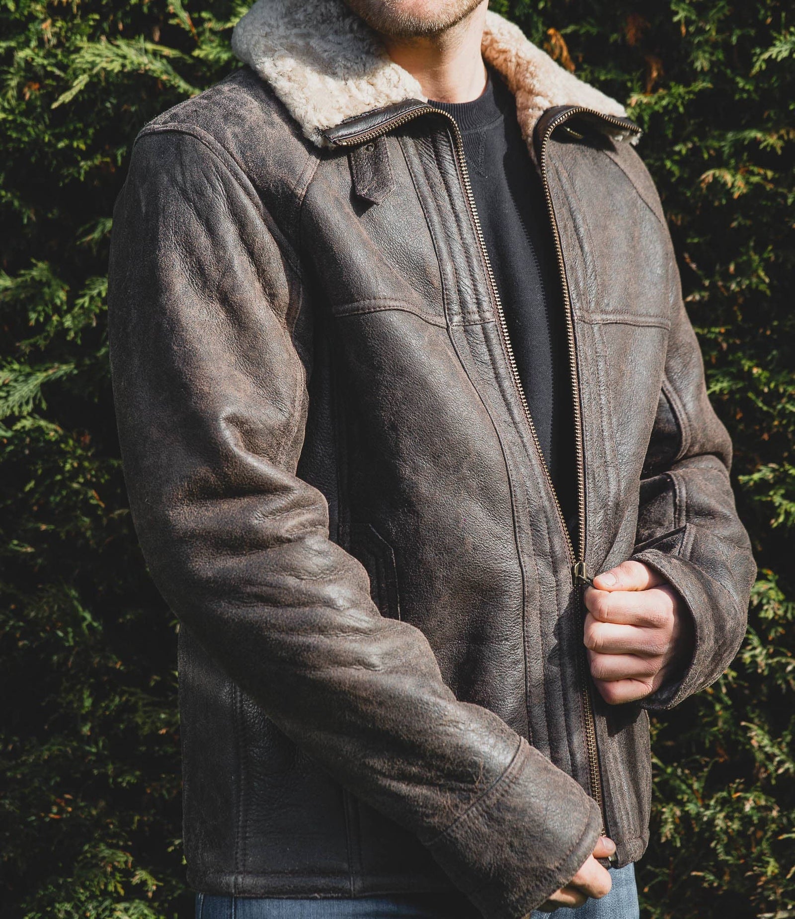 Nordvek mens sheepskin jacket 702-100 chocolate on model stood infront of bush