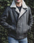 Nordvek mens sheepskin jacket 703-100 dark brown on model front stood infront of bush