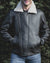 Nordvek mens sheepskin jacket 703-100 dark brown on model front stood infront of bush