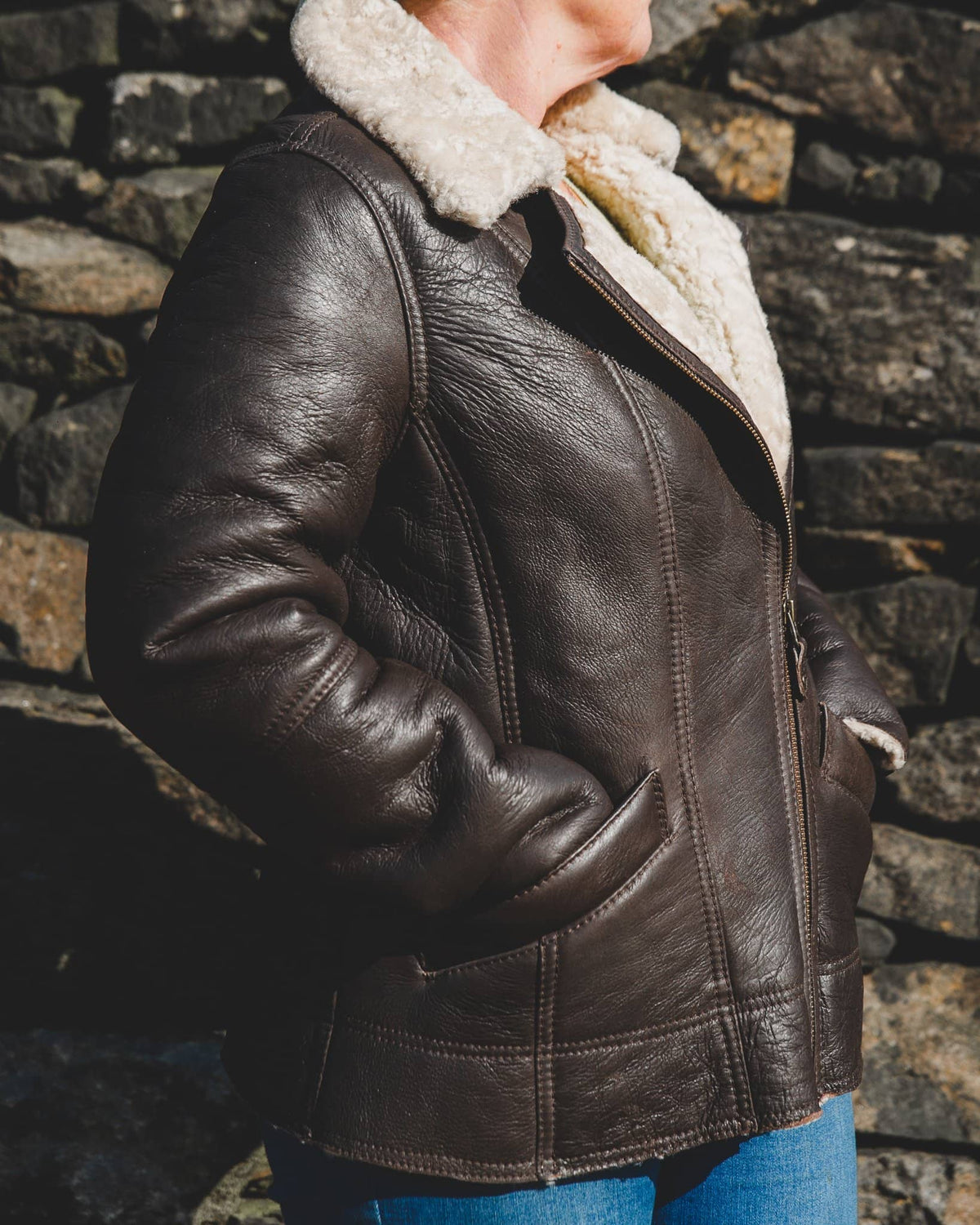 Nordvek womens sheepkin jacket 705-100 side on model stood infront of wall