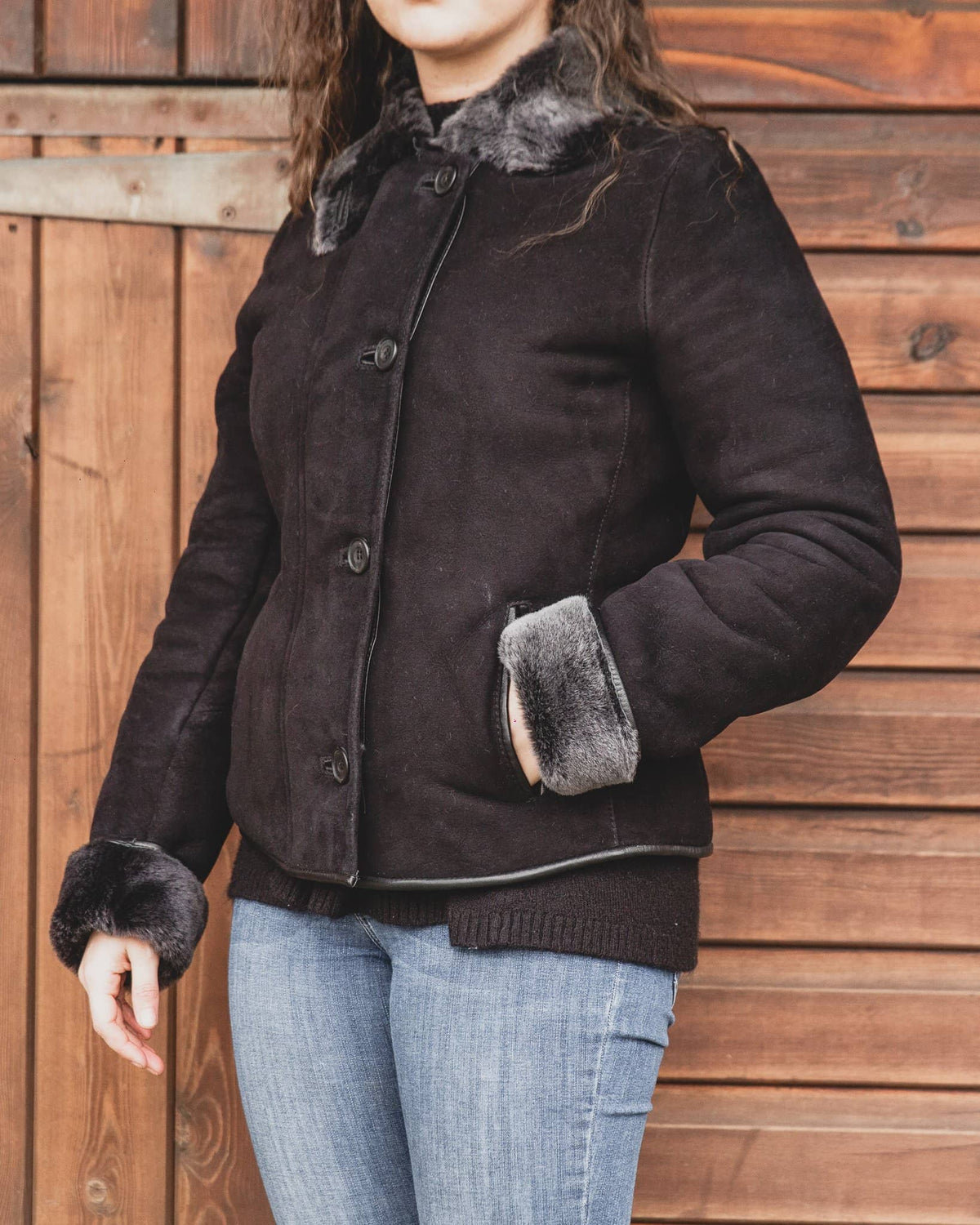 Nordvek womens sheepskin jacket 706-100 black front on model stood infront of stable