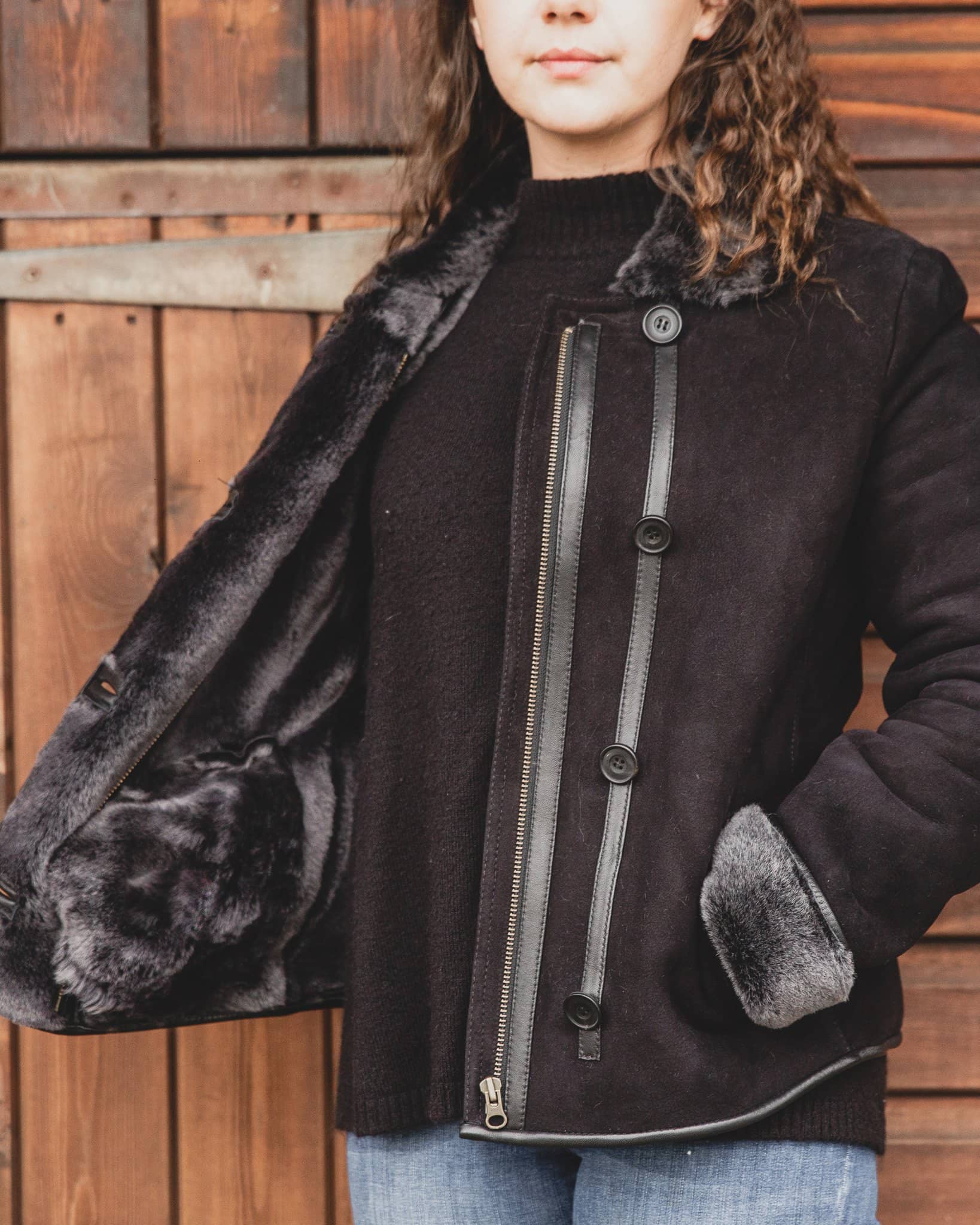 Nordvek womens sheepskin jacket 706-100 black front on model stood infront of stable
