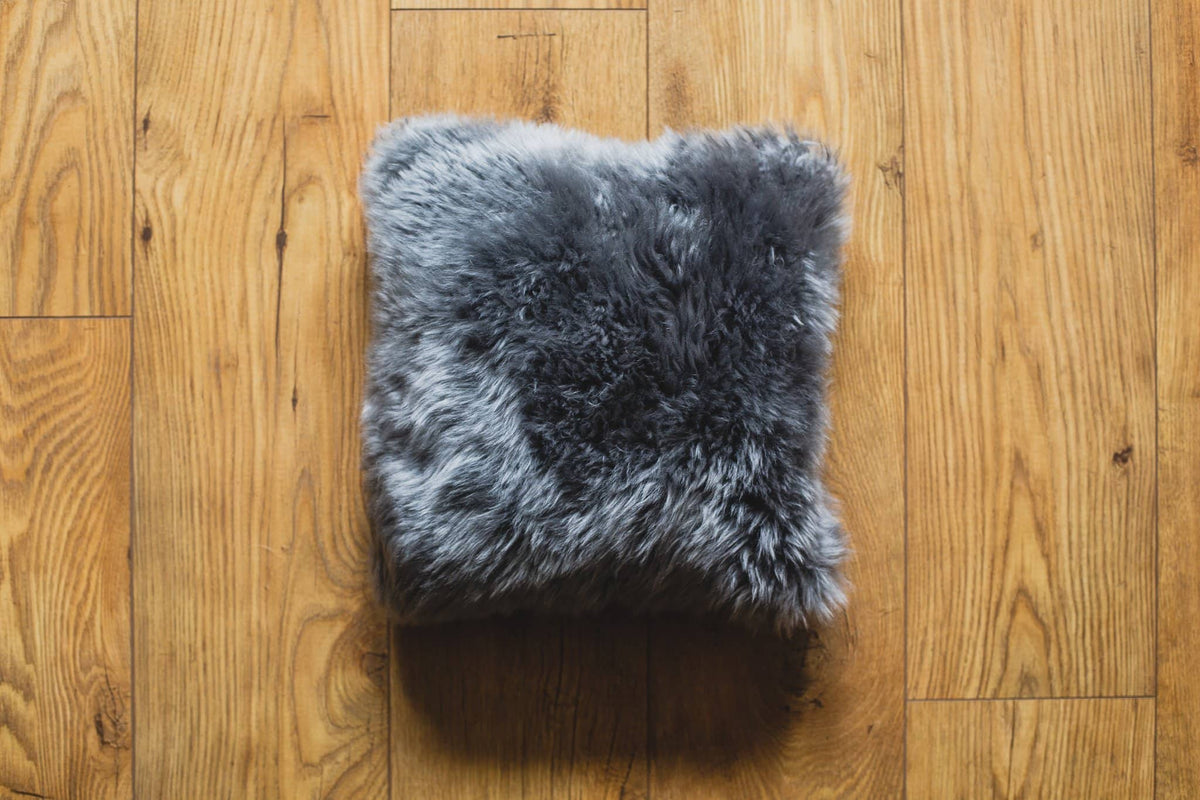 Nordvek sheepskin cushion 9001-100 grey on wooden floor
