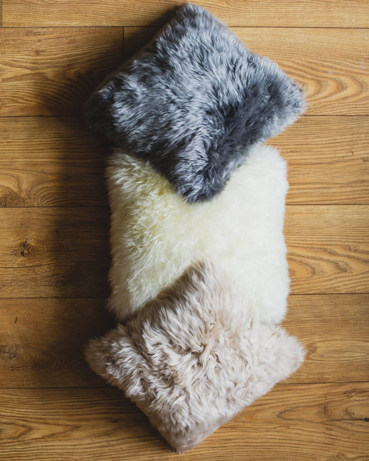 Nordvek sheepskin cushion 9001-100 group on wooden floor