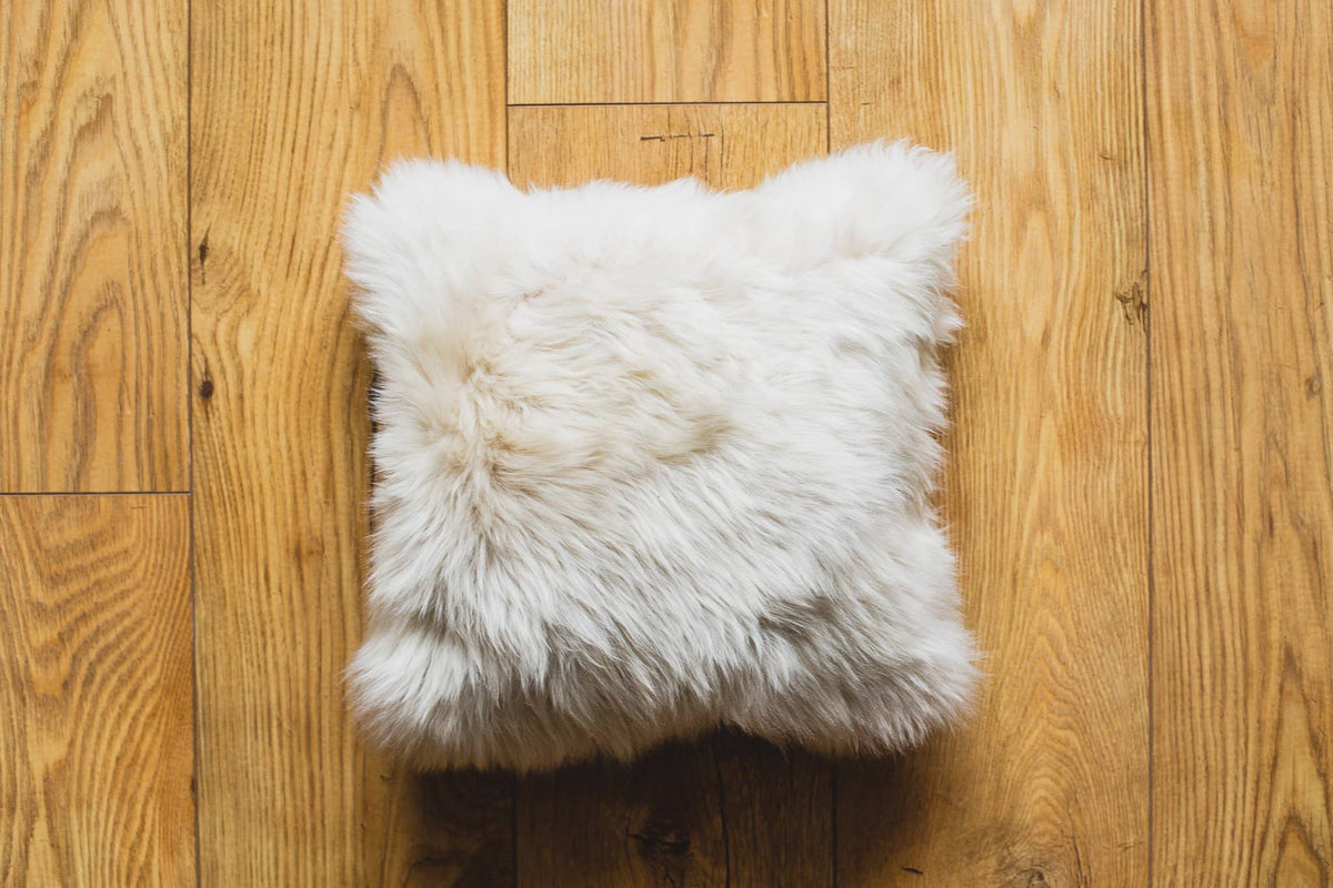 Nordvek sheepskin cushion 9001-100 white on wooden floor