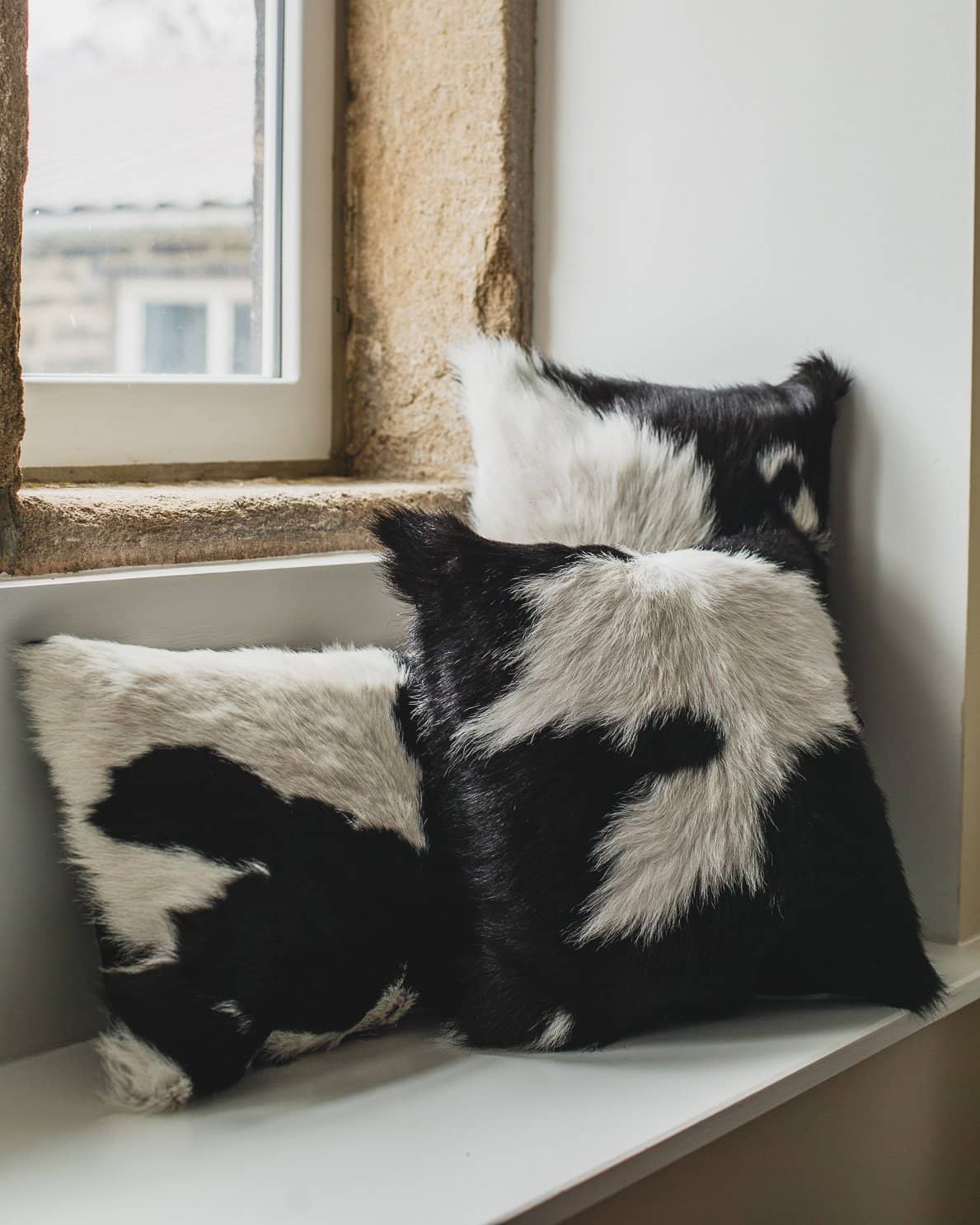 Nordvek cowhide cushion group shot on window sill 9007-100
