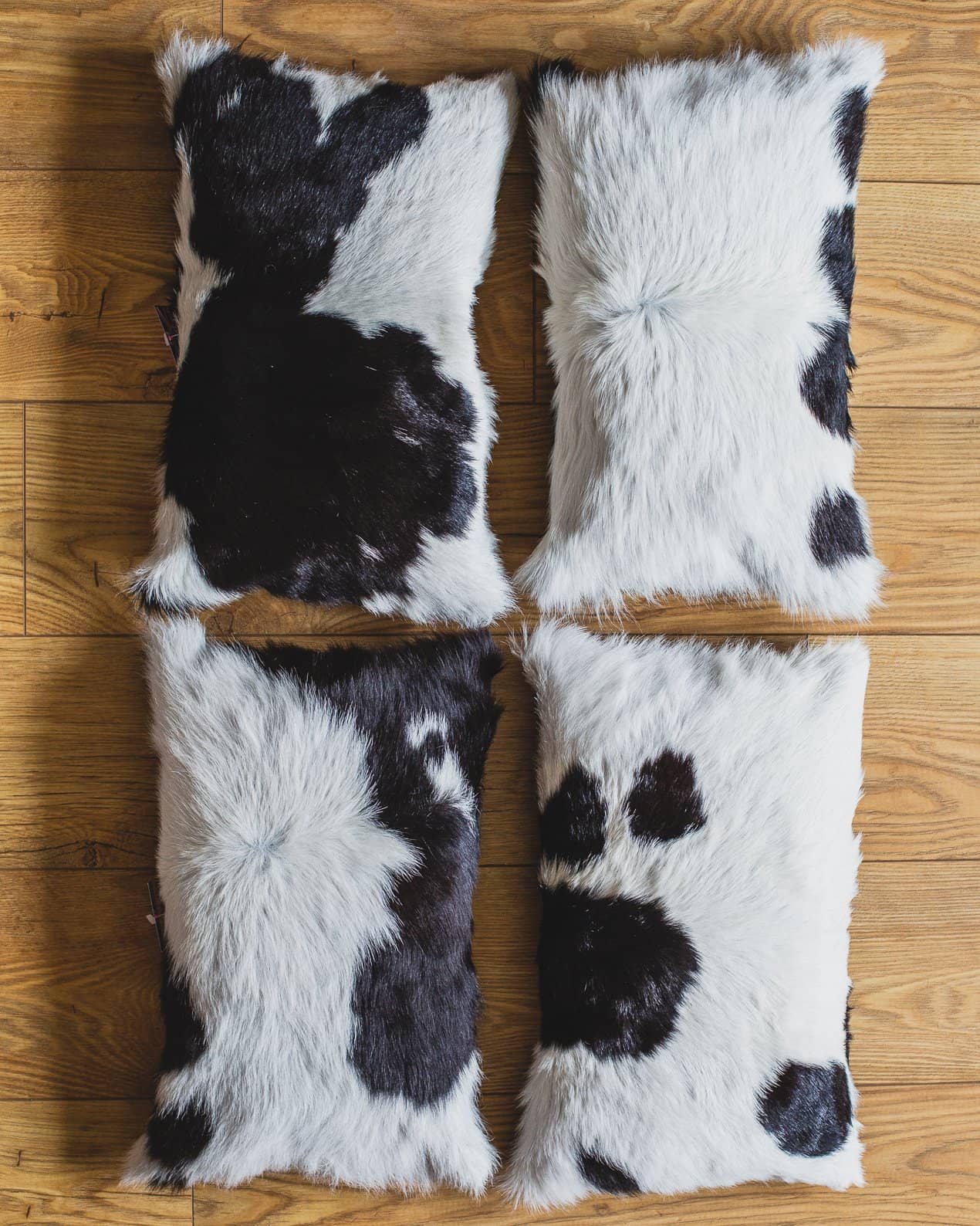 Nordvek cowhide cushion group shot on window sill 9008-100