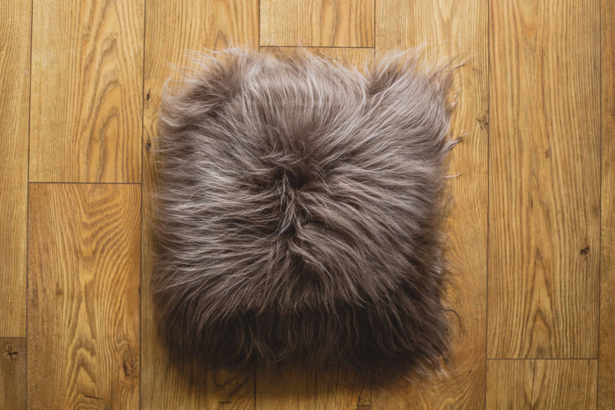 Nordvek Icelandic Sheepskin Cushion 9010-100 taupe on wooden floor