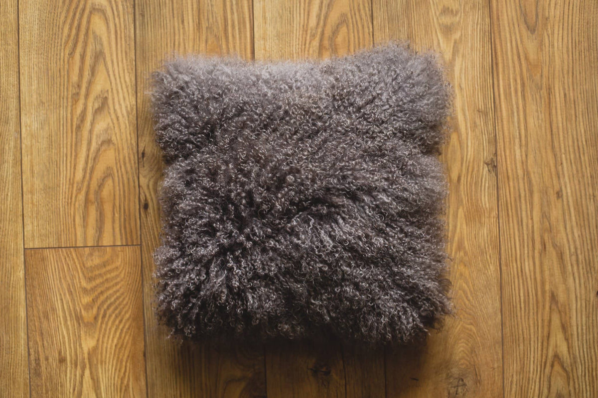 Nordvek mongolian sheepskin cushion 9013-100 grey on wooden floor