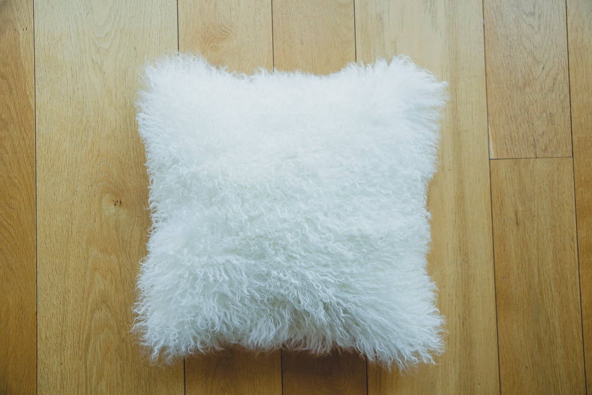Nordvek mongolian sheepskin cushion 9013-100 white on wooden floor