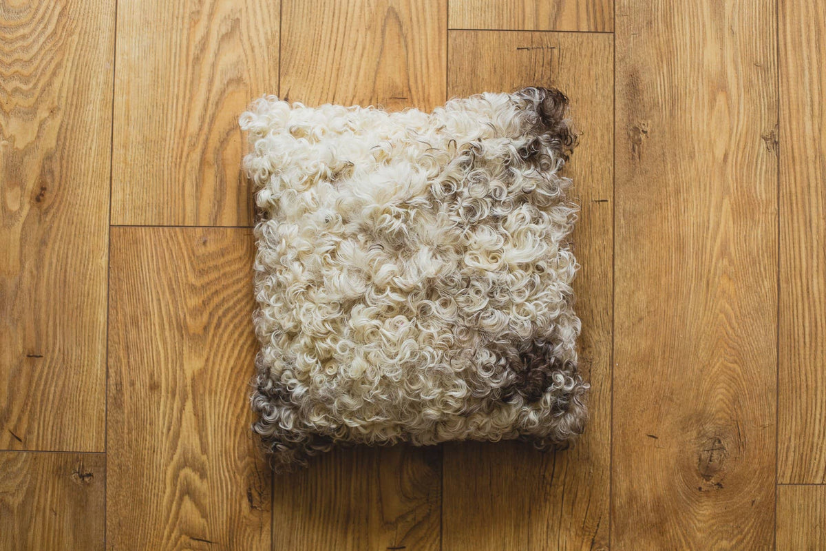 Nordvek Spanish Sheepskin Cushion 9016-100 Light single on wooden floor