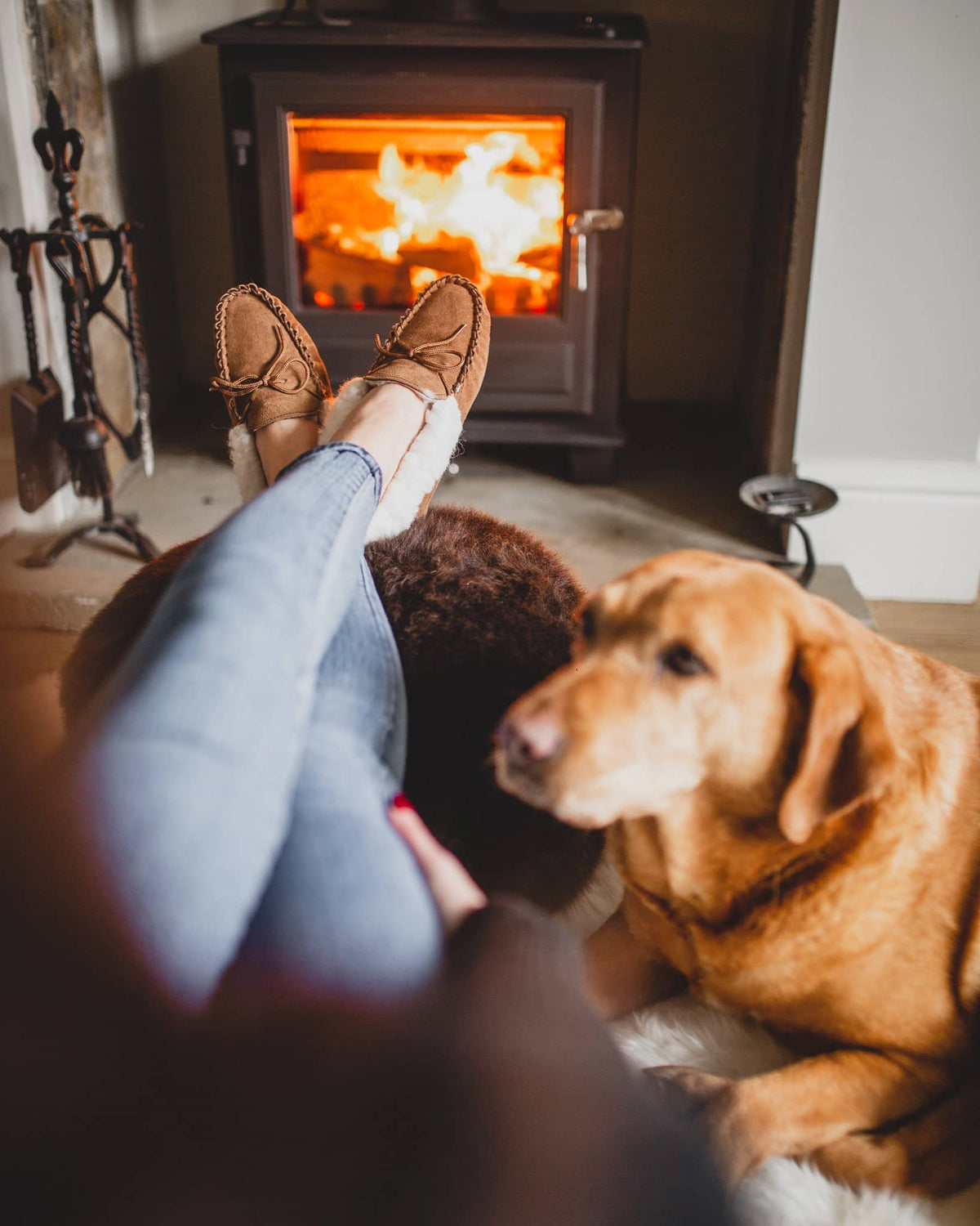 Nordvek womens moccasins hard sole  418-100 chestnut in front of fire with dog