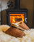 Shepherd Mens sheepskin slippers HUGO cognac pair in front of fire