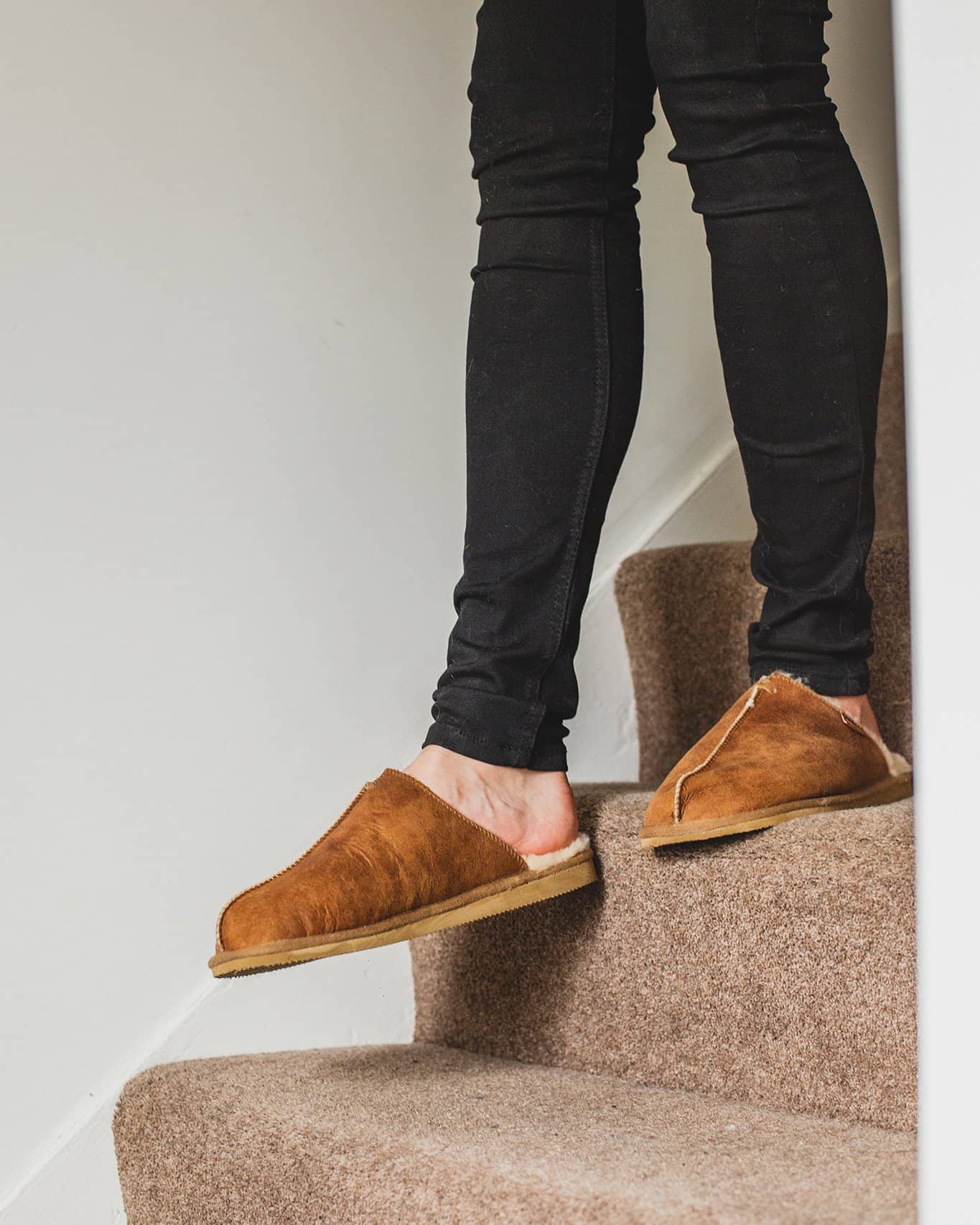 Shepherd Mens sheepskin slippers HUGO cognac pair in front of fire