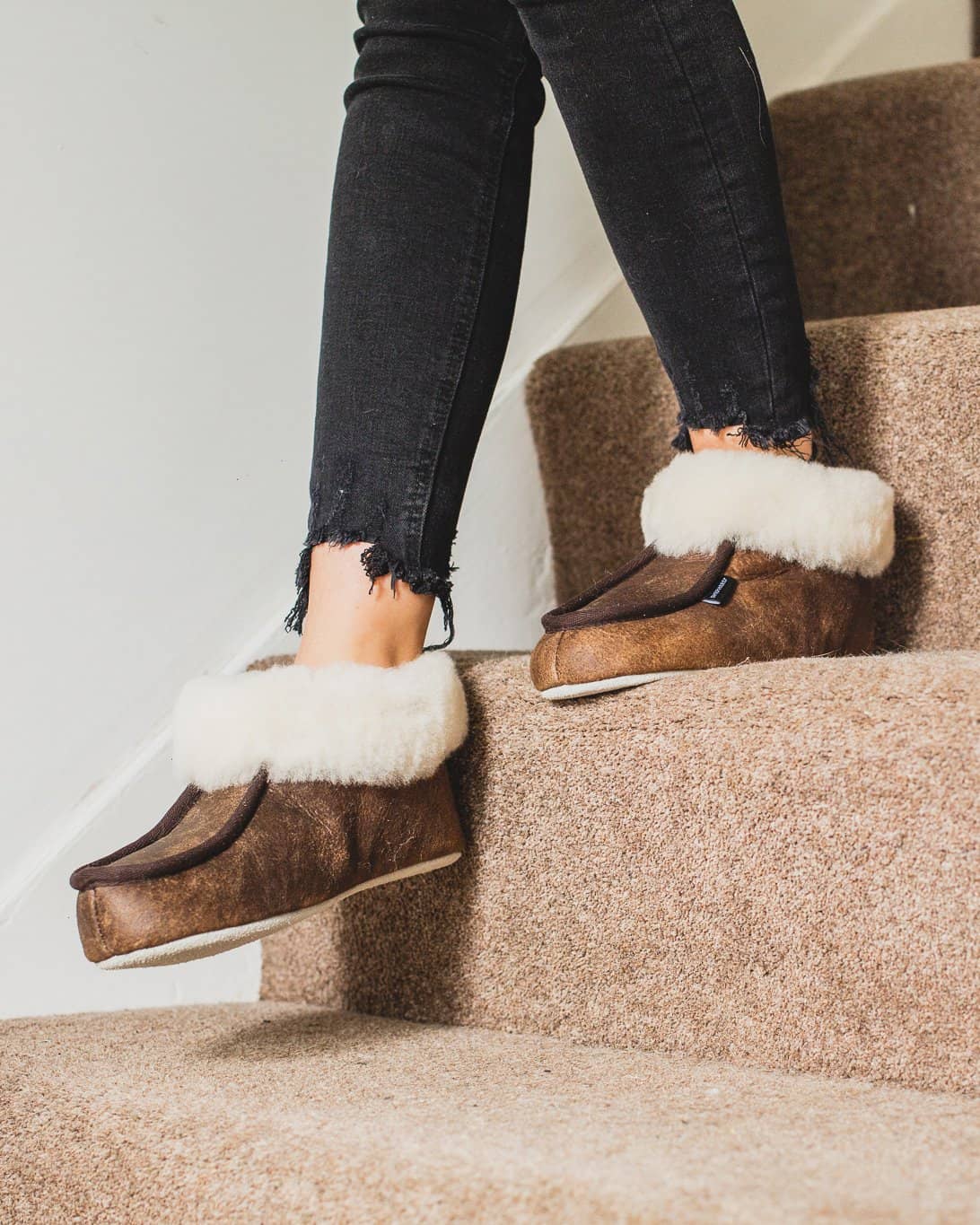 Shepherd womens sheepskin slippers MOA oiled antique pair in front of fire